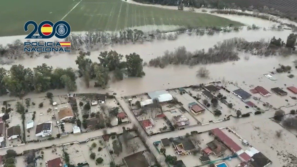 Vista aérea de las inundaciones en Córdoba hoy por el Guadalquivir captada por la Policía Nacional, mostrando viviendas de la vega anegadas y el aeropuerto rodeado de agua.