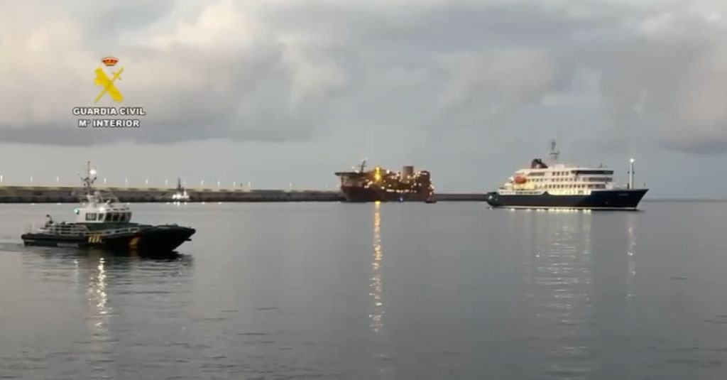 Patrullera de la Guardia Civil navegando junto al crucero MV Hondius en las maniobras de aproximación al muelle.