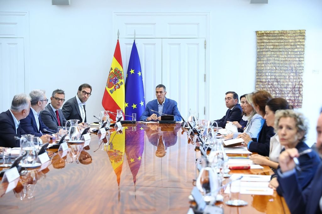 Pedro Sánchez preside una reunión del comité especializado en Moncloa junto a sus ministros y altos cargos en torno a una mesa ovalada.