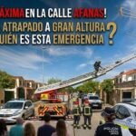 Fotografía de una operación de rescate de emergencia en la calle Afanas de Jerez, donde se ve a bomberos en lo alto de una autoescala y a agentes de la Policía Local de Jerez regulando la situación junto a varios vehículos policiales y una multitud de vecinos observando.